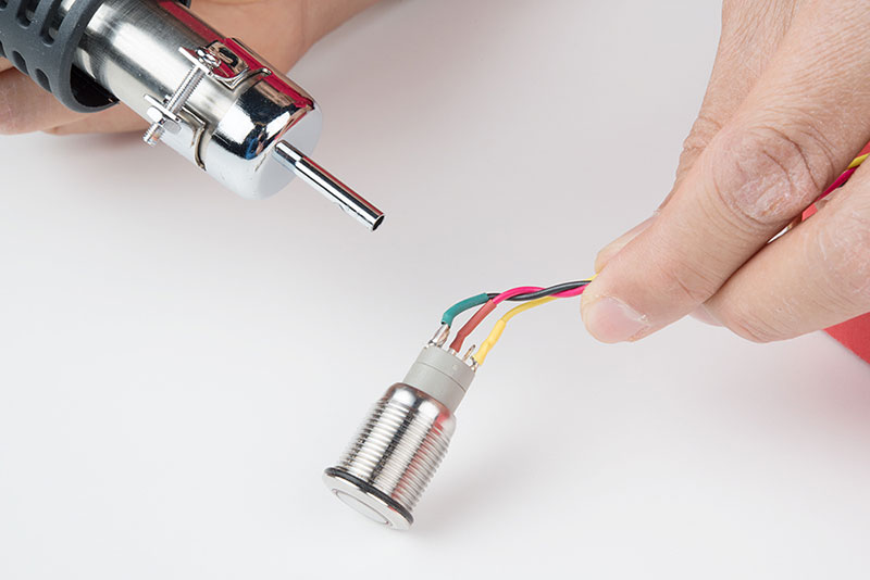 Solder joint sealed with heat-shrink