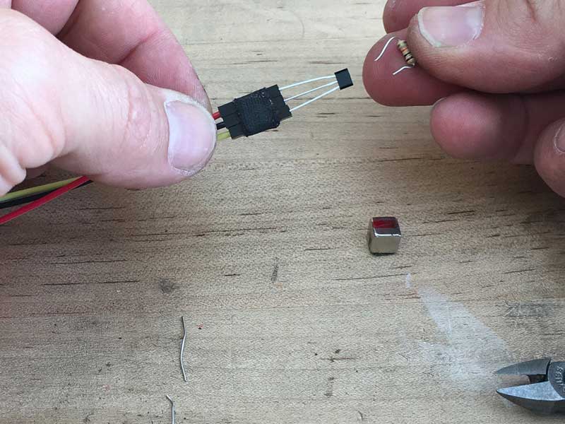 Trim legs of resistor & push them in to contact