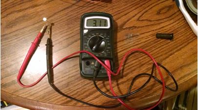 The ohmmeter reads a value of 3.11 Kilo-ohms