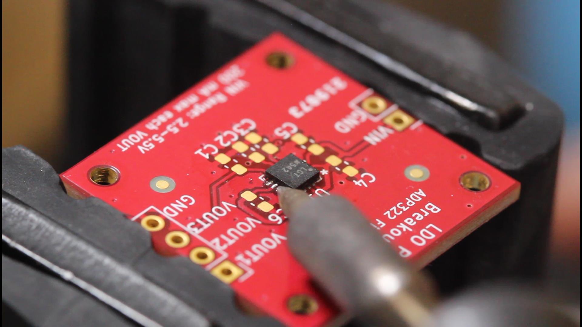 Using a soldering iron to break bridged solder points