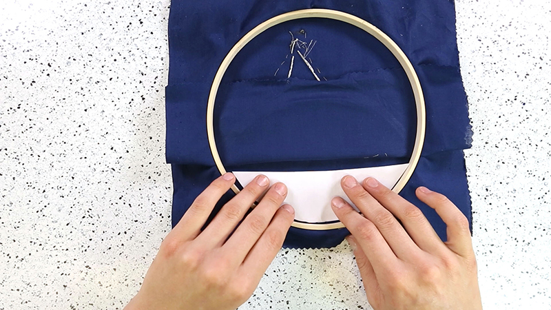 Tighten the hoop back up with the fabric bent back 