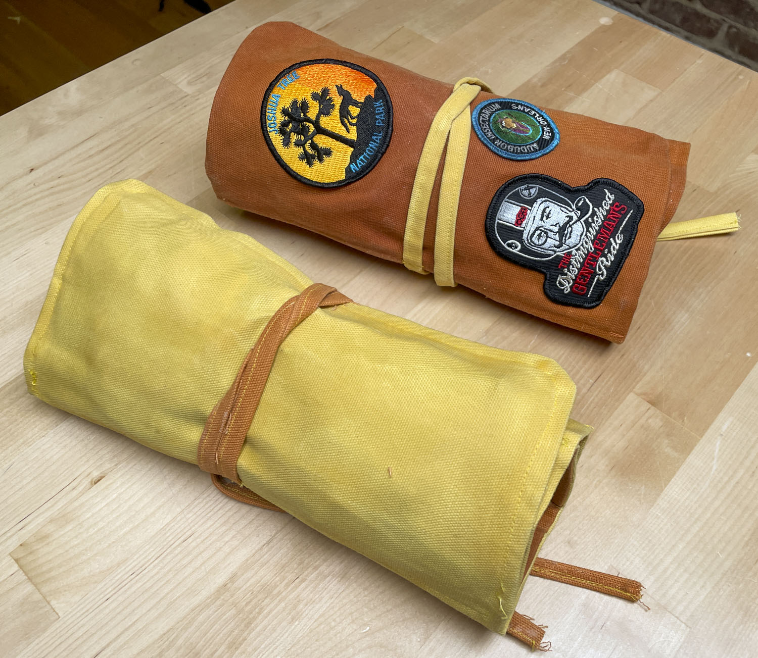 two waxed canvas tool rolls