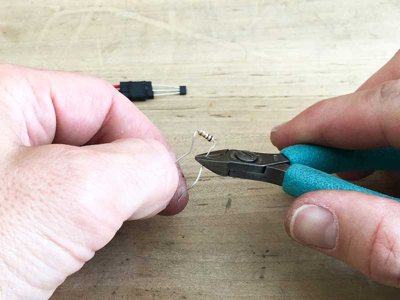 Trim legs of resistor & push them in to contact